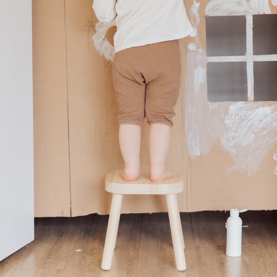 Small child standing on a chair