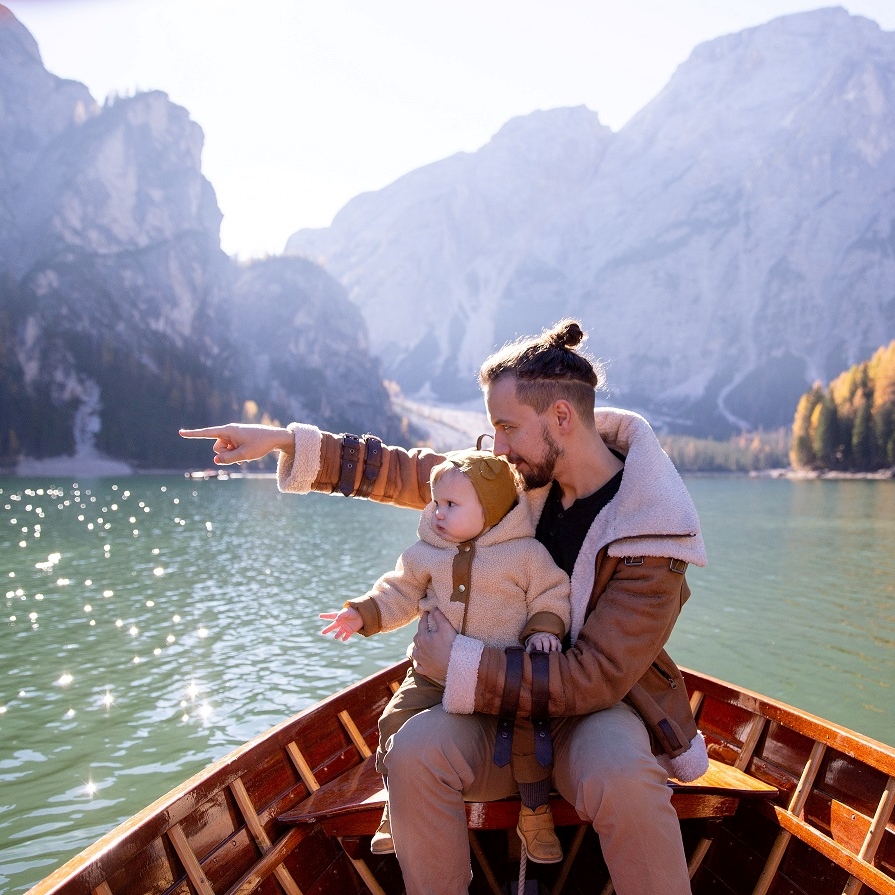 A man with a child on a boat